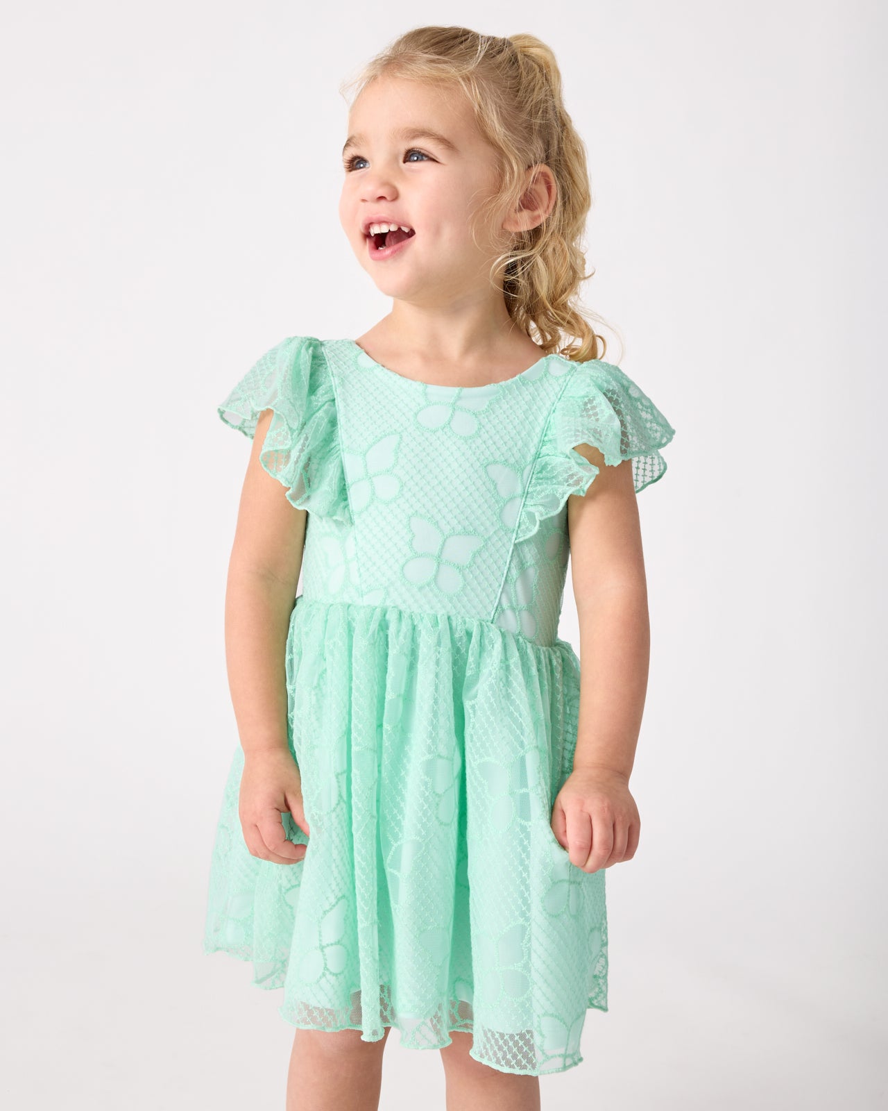 Girl wearing the Butterfly Brook Smocked Flutter Dress