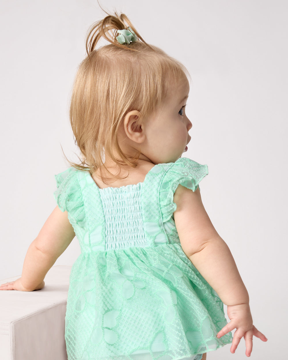 Back view of child wearing the Butterfly Brook Smocked Flutter Dress with Bloomer