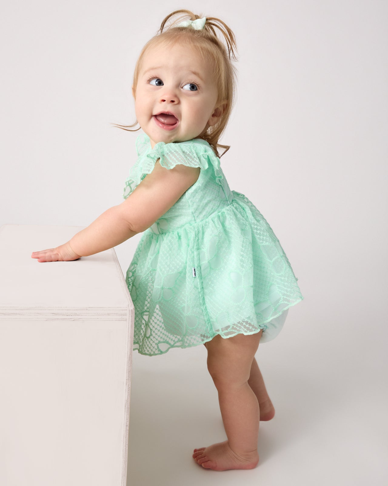 Baby wearing the Butterfly Brook Smocked Flutter Dress with Bloomer