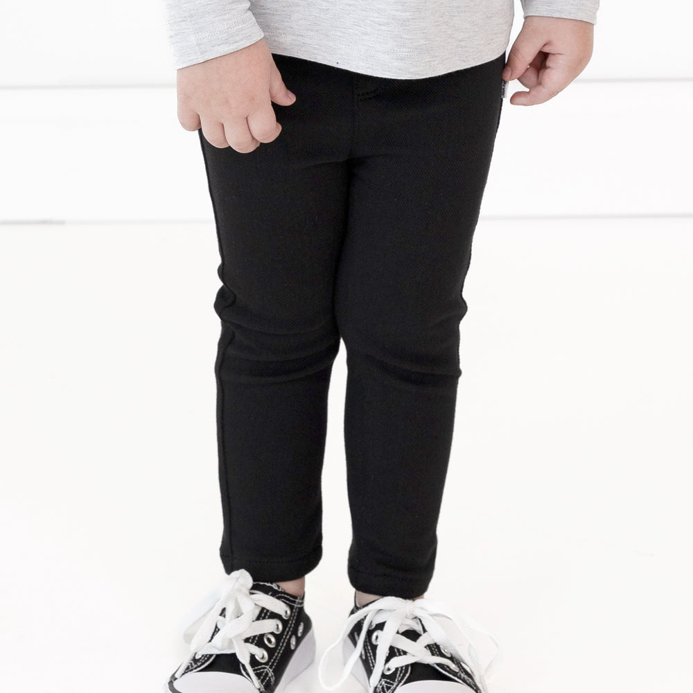 Close up image of a child wearing Black Denim Jeggings