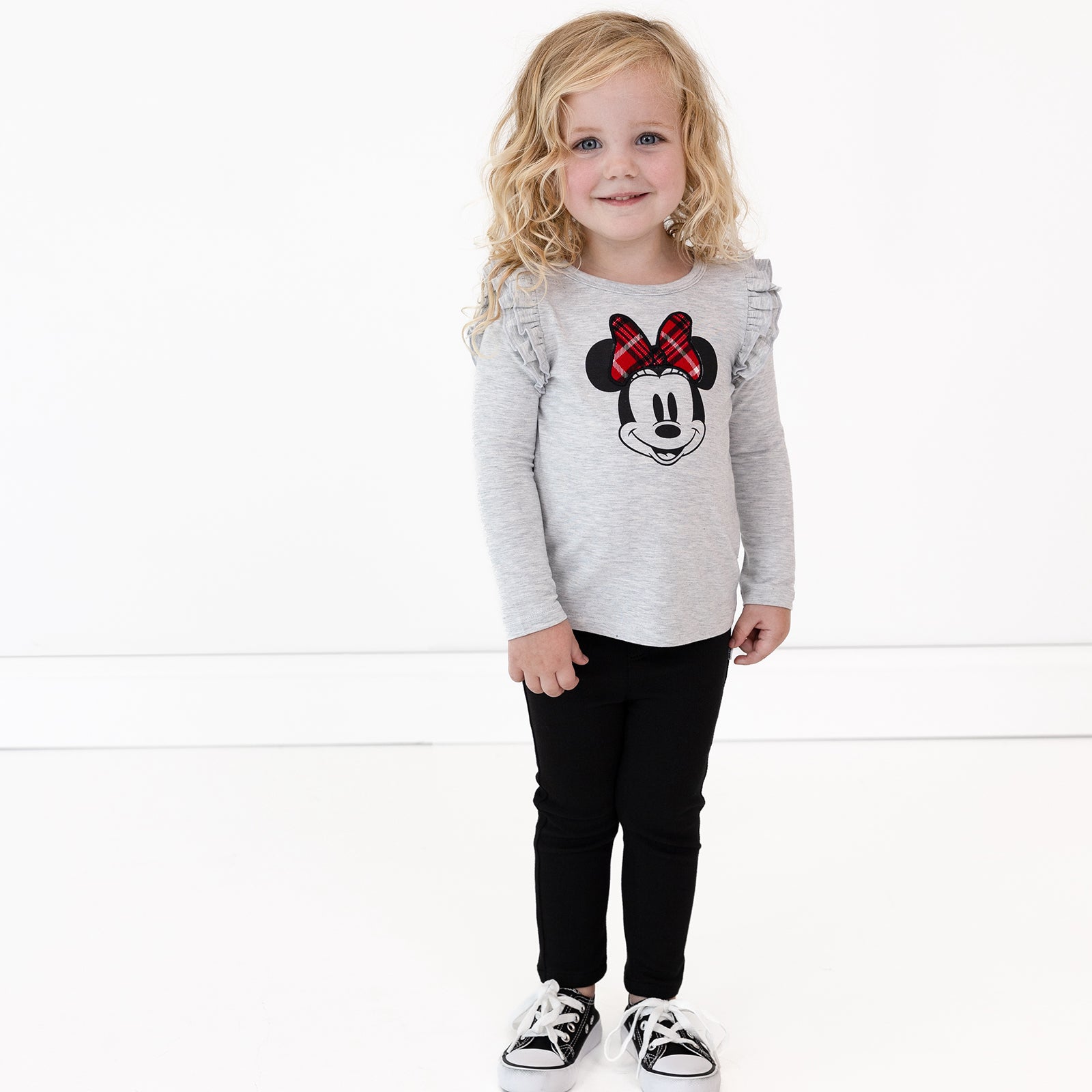 Image of a child wearing Black Denim Jeggings and a Vintage Minnie Flutter Tee