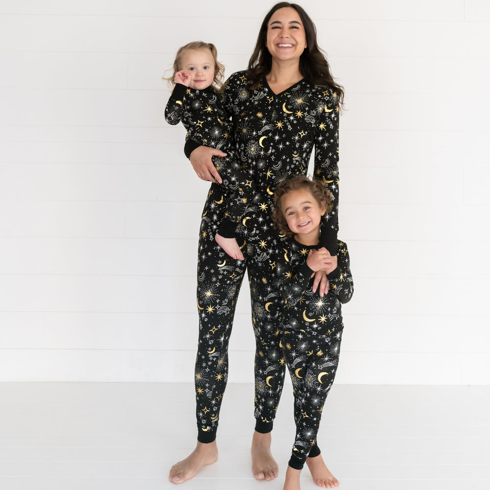 image of a woman and her two children wearing matching Celebration Stars pjs in women's and children's styles. Children are wearing zippy and two piece styles.