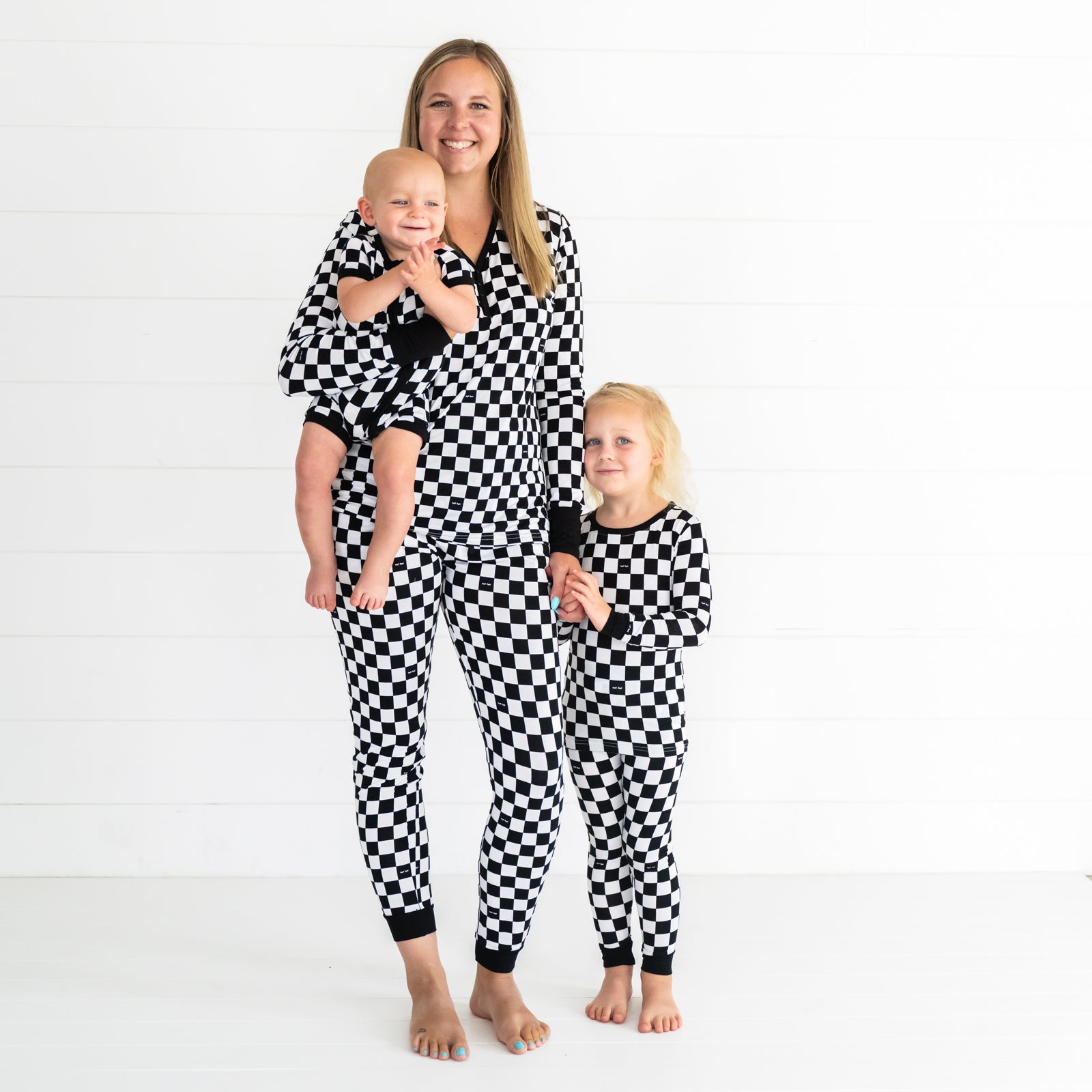 Mother and her two children wearing matching Cool Check pjs. Kids are wearing shorty zippy and two piece styles