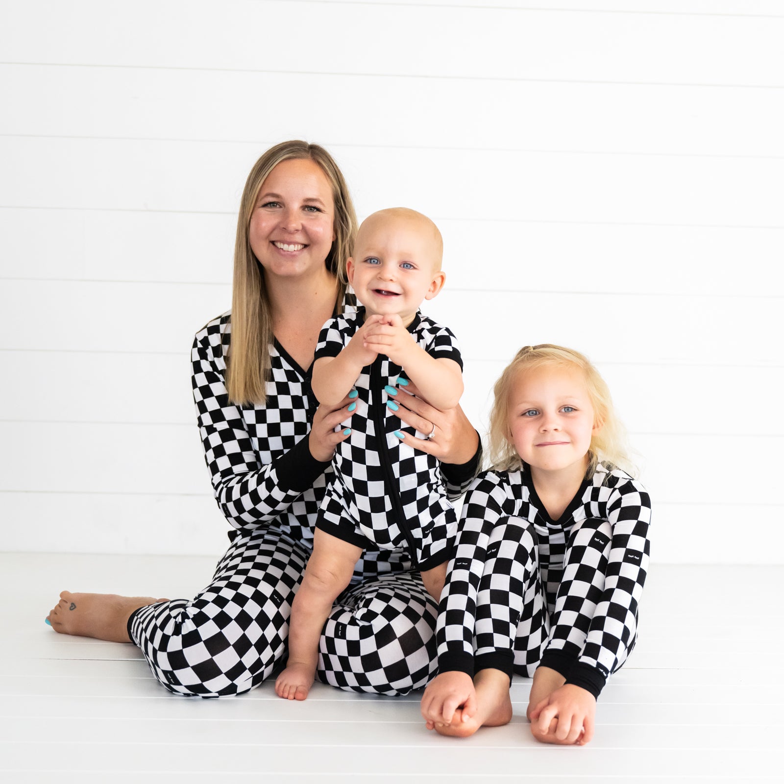 Mother and her two children wearing Cool Checks pjs. Children are wearing shorty zippy and two piece styles