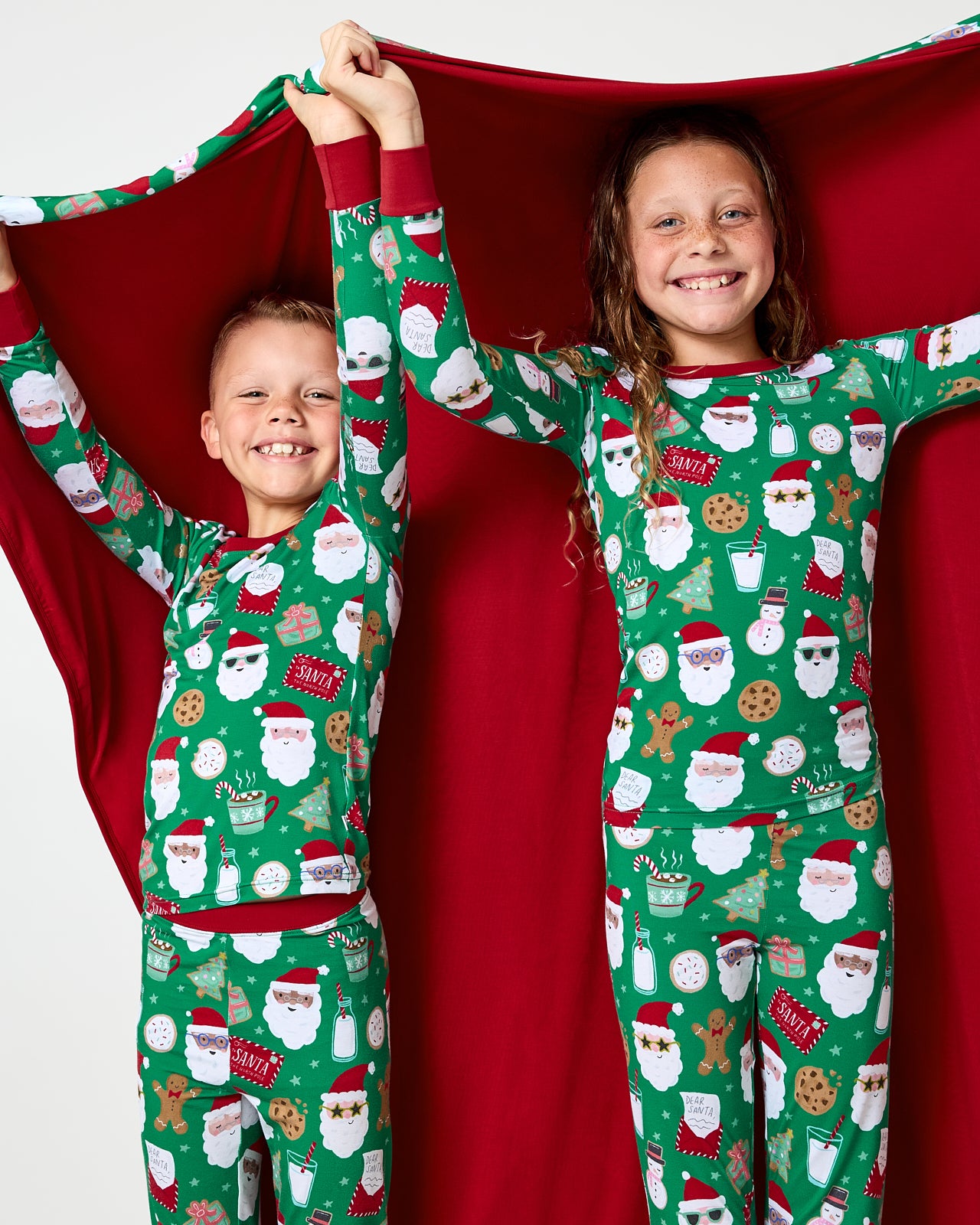 Two children holding up the Cookies for Santa Large Cloud Blanket®
