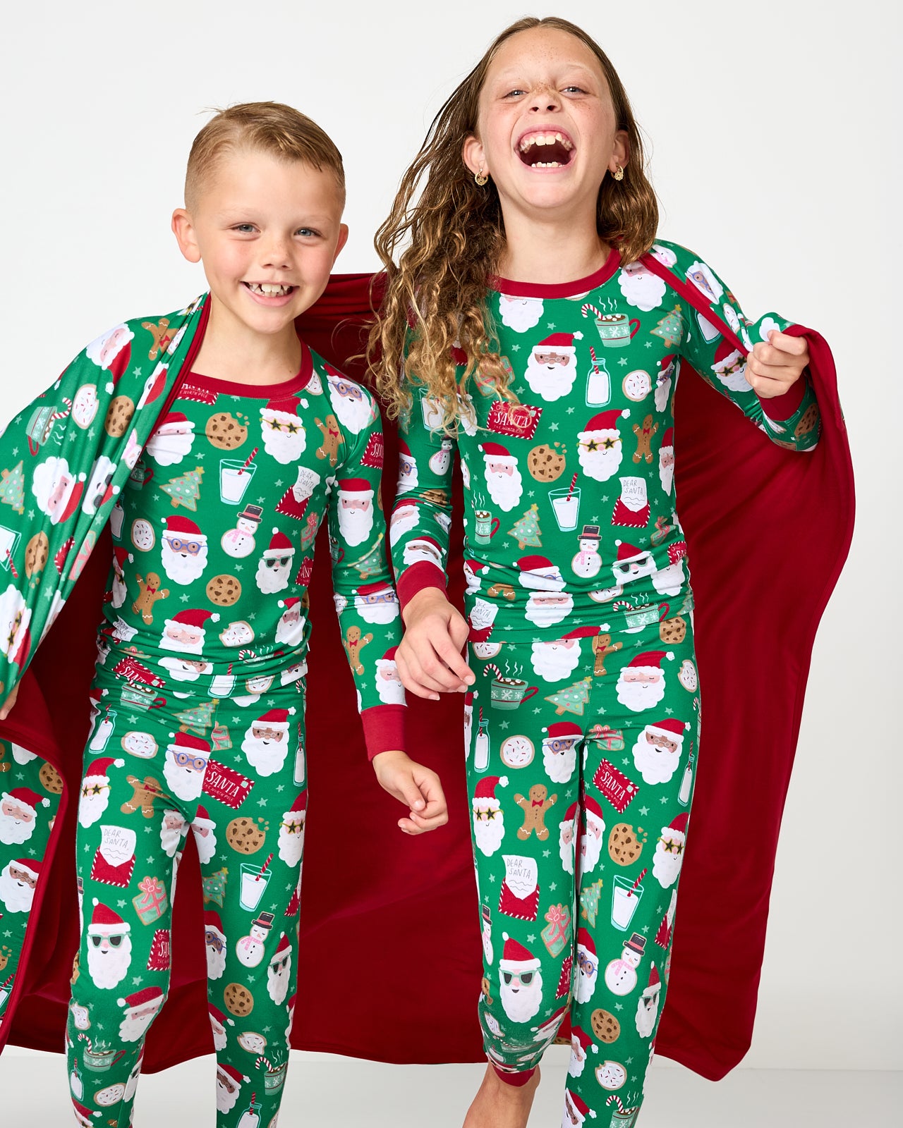Two children wrapped in the Cookies for Santa Large Cloud Blanket®