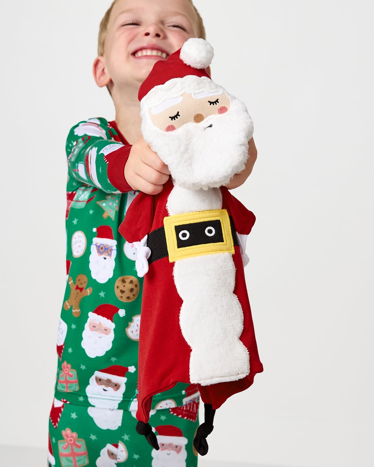Child holding up the Nick the Santa Sleepyhead Lovey