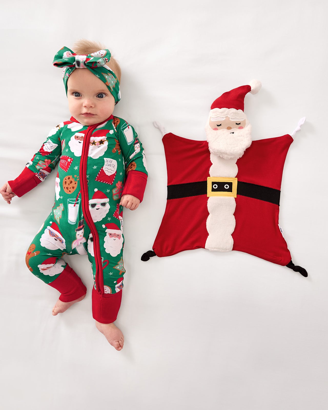 Baby laying next to the Nick the Santa Sleepyhead Lovey