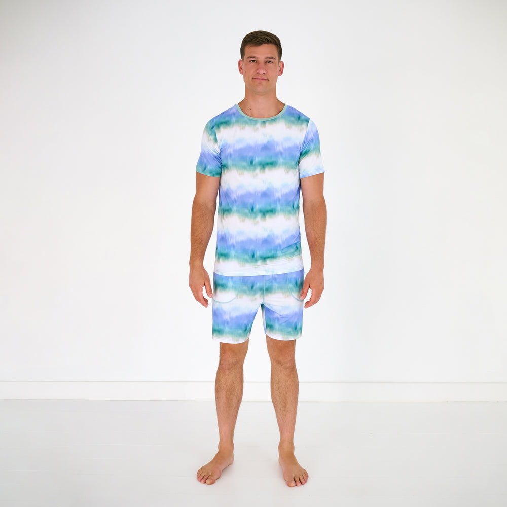 Standing man wearing the Blue Cosmic Mist Men's Pajama Shorts with a matching pajama top