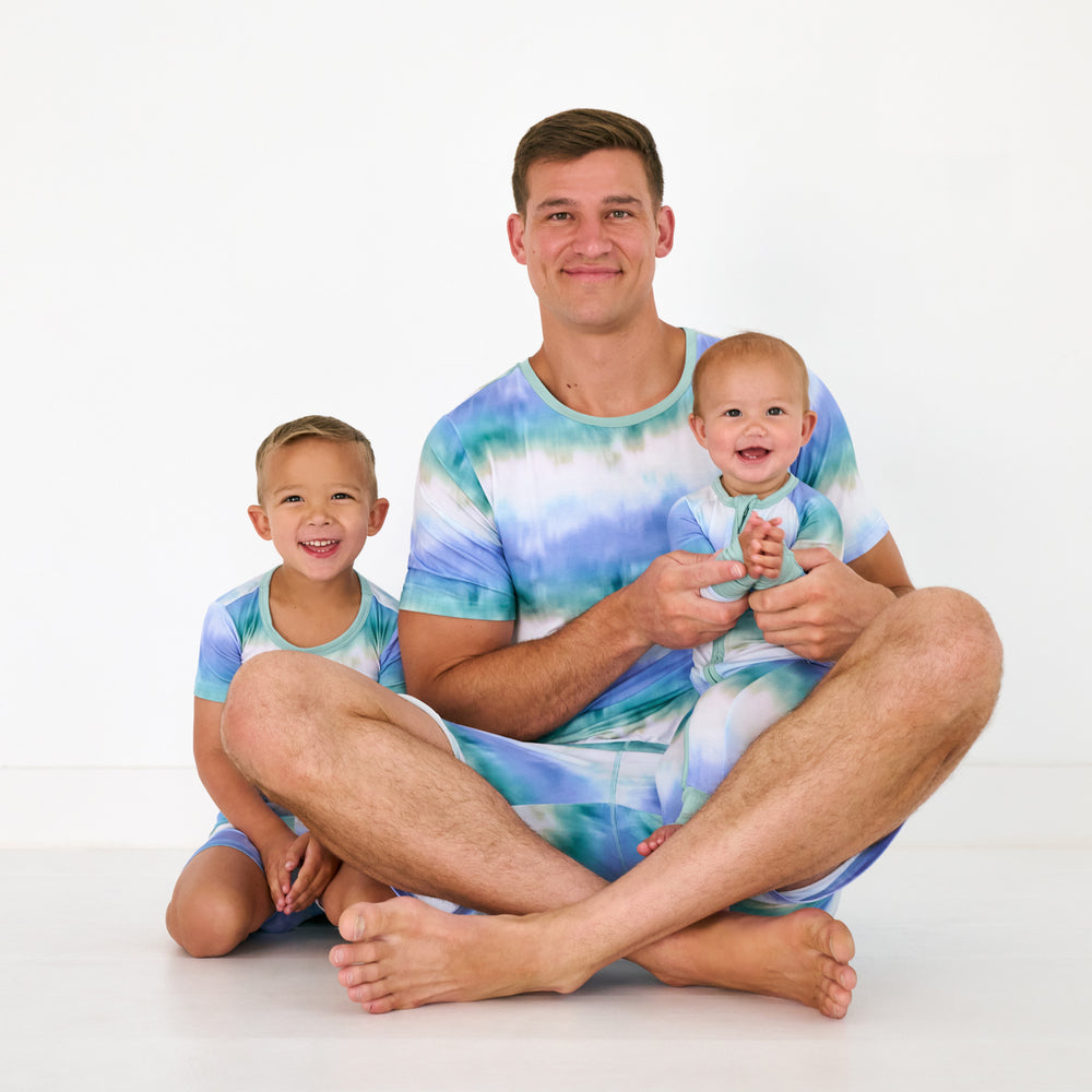Father and two children wearing matching Blue Cosmic Mist pajamas