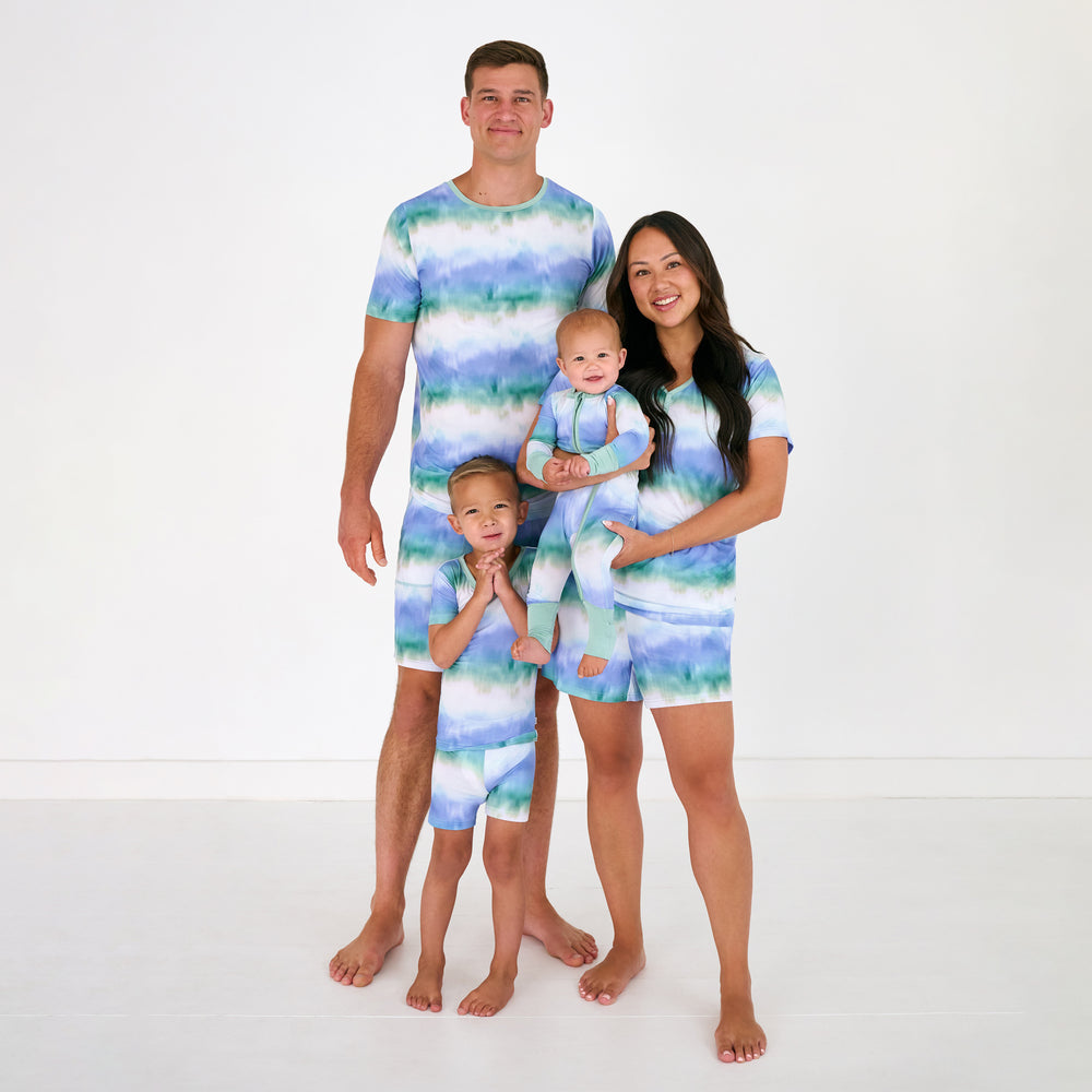 Family of four wearing matching Blue Cosmic Mist bamboo pajamas