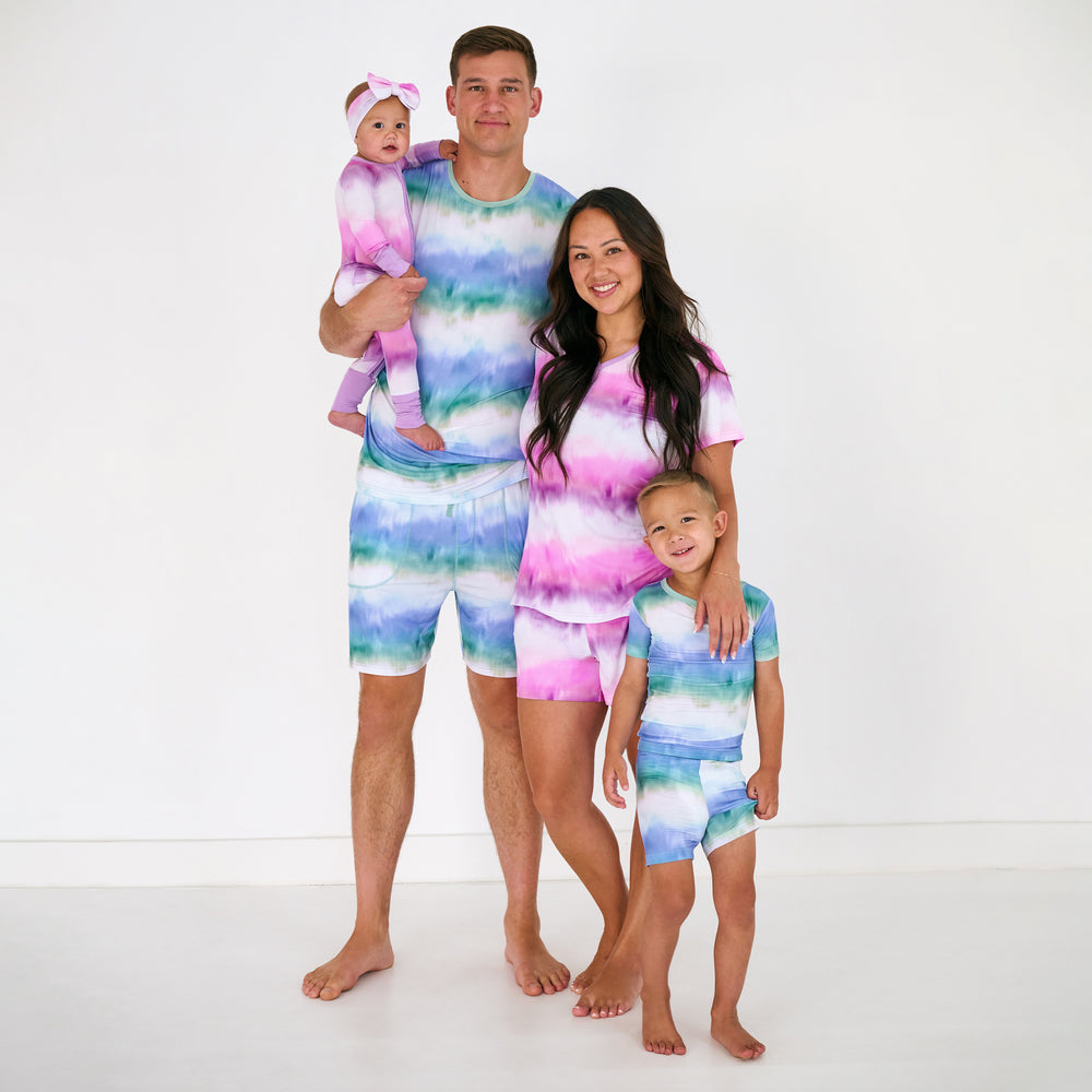 Family of four wearing matching Cosmic Mist family matching pajamas