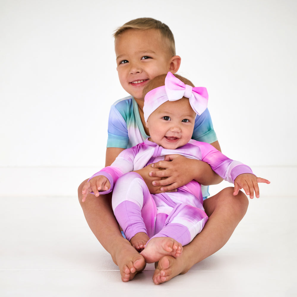 Two children wearing matching Cosmic Mist kids pajamas