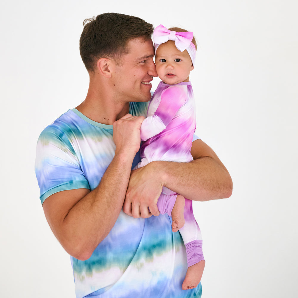Father and daughter wearing matching Cosmic Mist pajamas