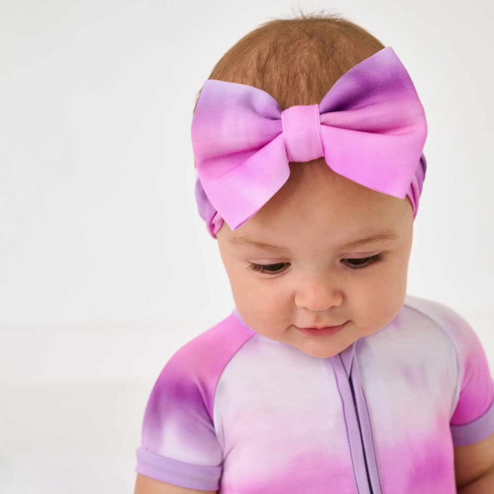 Close up of baby wearing the Pink Cosmic Mist Luxe Bow Headband