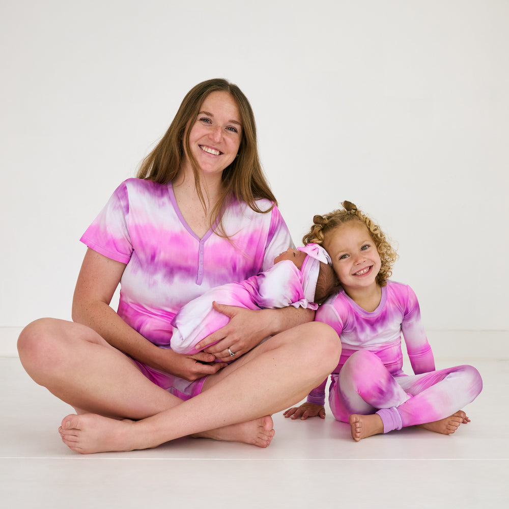 Mother and two children wearing matching Pink Cosmic Mist bamboo sleepwear