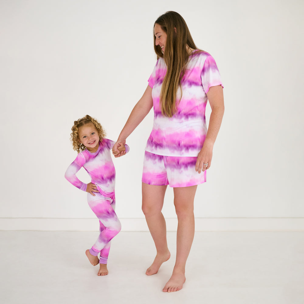 Mother and daughter holding hands wearing matching Pink Cosmic Mist bamboo pajamas