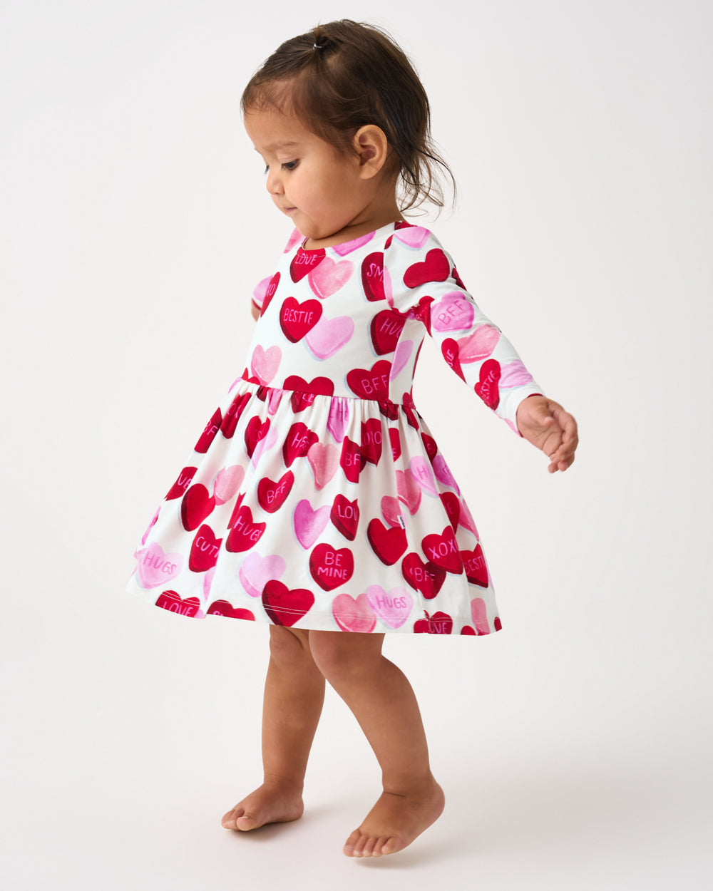 Toddler wearing the Candy Cuties Bow Back Dress with Bodysuit