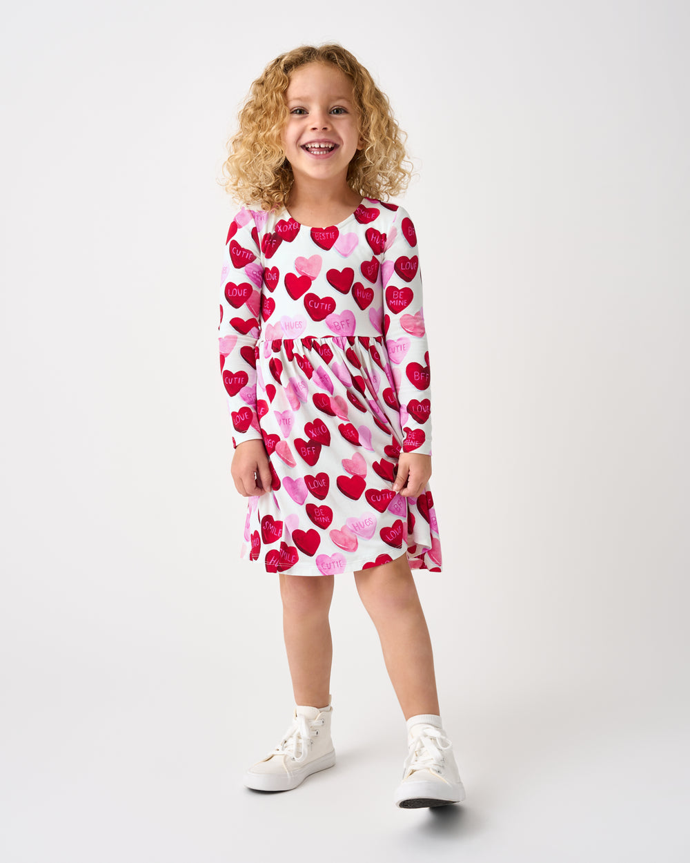 Standing girl wearing the Candy Cuties Bow Back Skater Dress