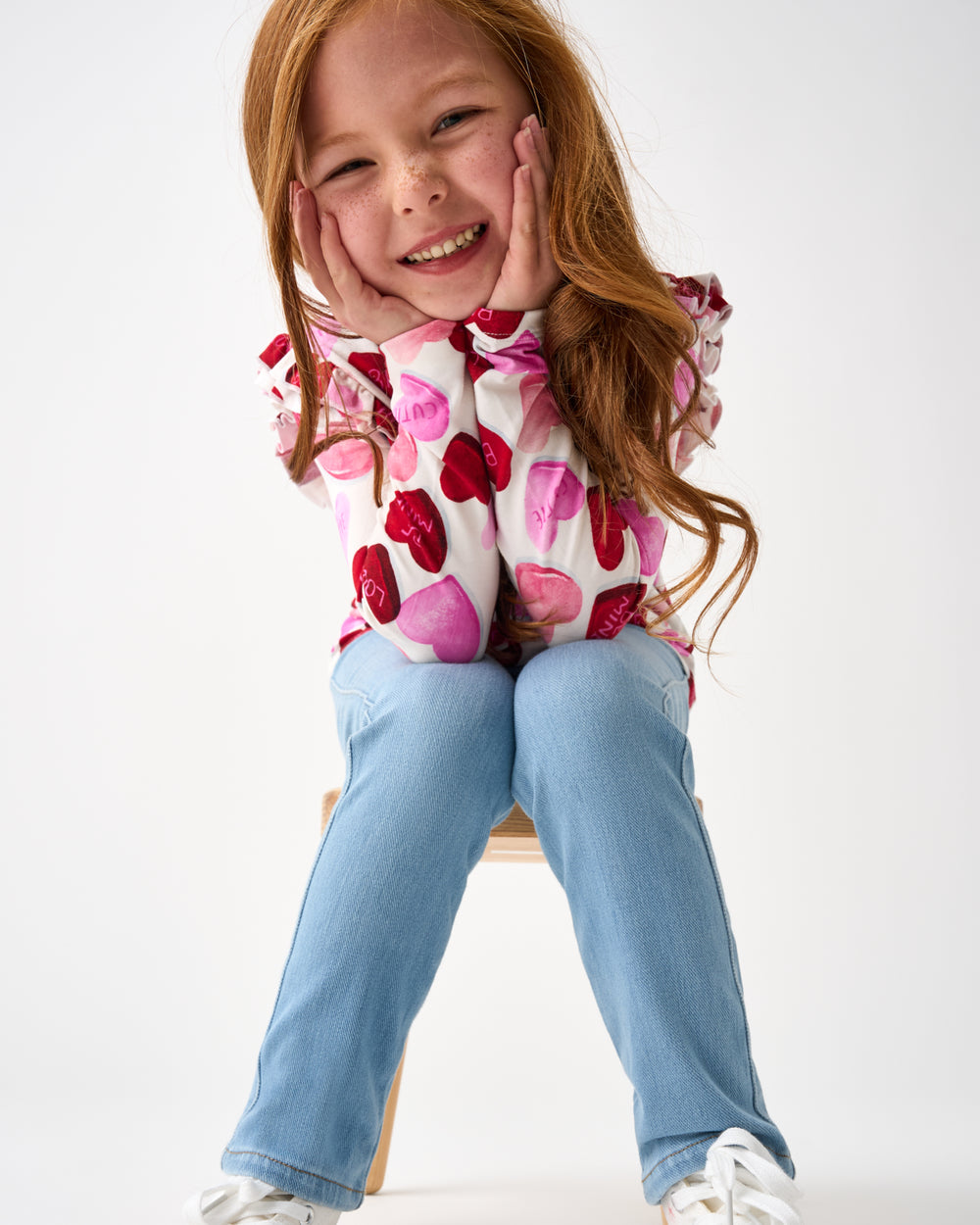 Girl wearing the Candy Cuties Flutter Tee with denim pants