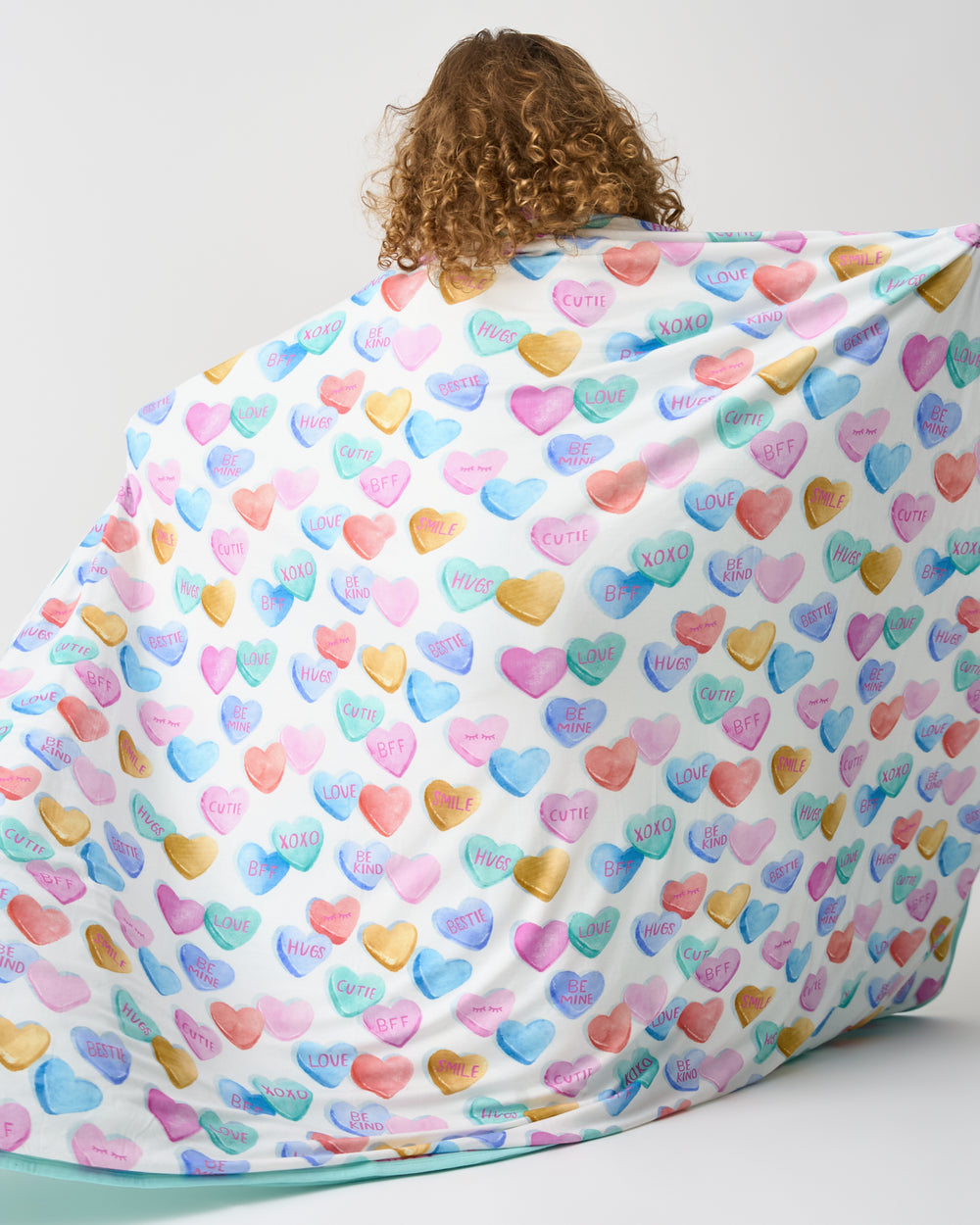 Back view of child holding up the Candy Cuties Large Cloud Blanket®