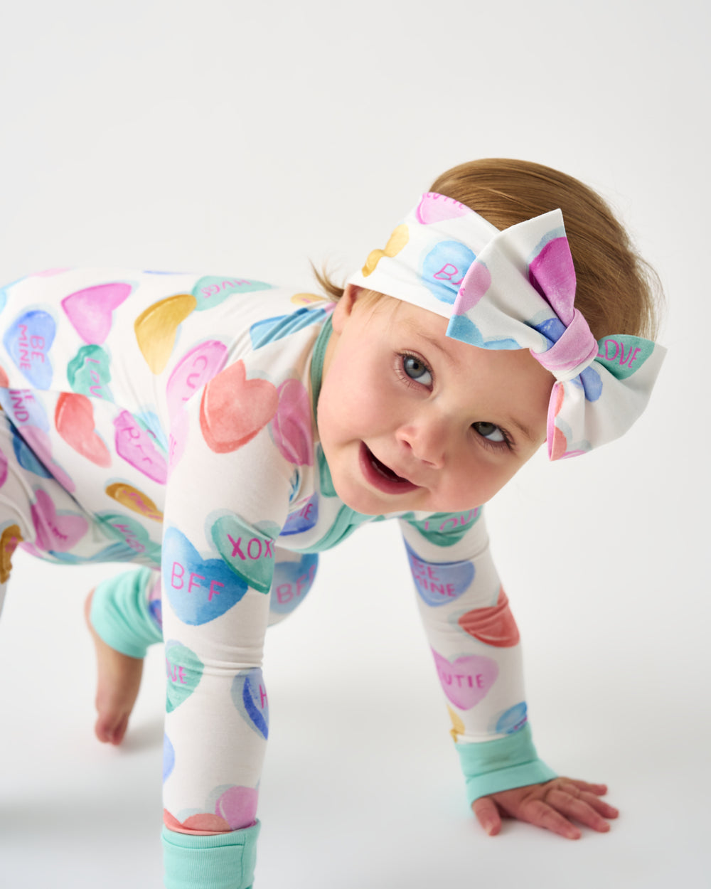 Crawling baby wearing the Candy Cuties Luxe Bow Headband