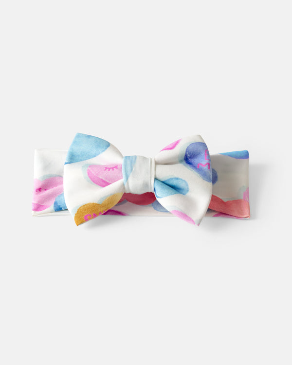 Flat lay of the Candy Cuties Luxe Bow Headband