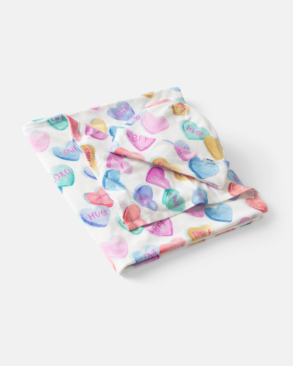 Flat lay of the Candy Cuties Swaddle & Hat Set