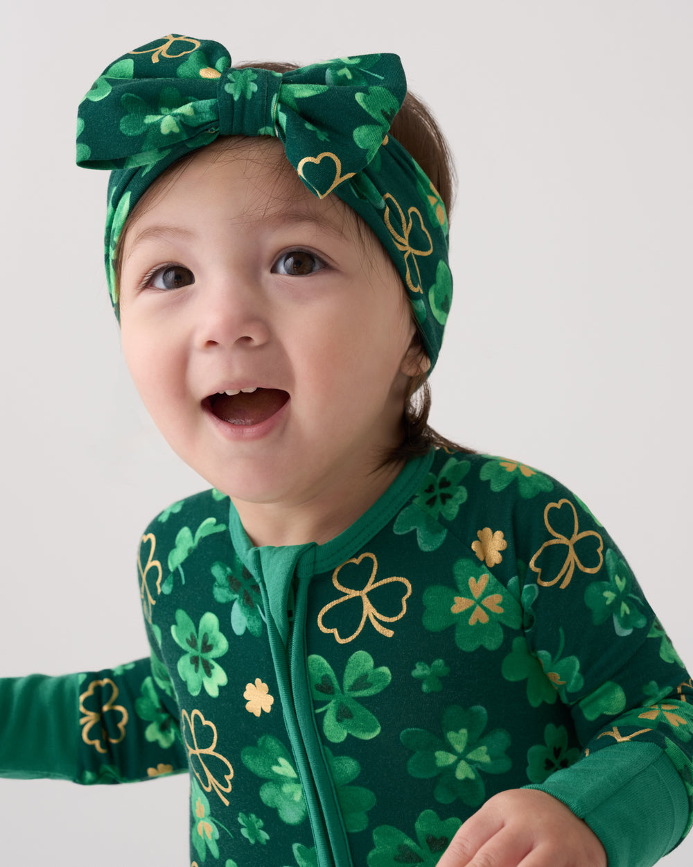 Close up of baby wearing the Clover Cuties Luxe Bow Headband and Zippy