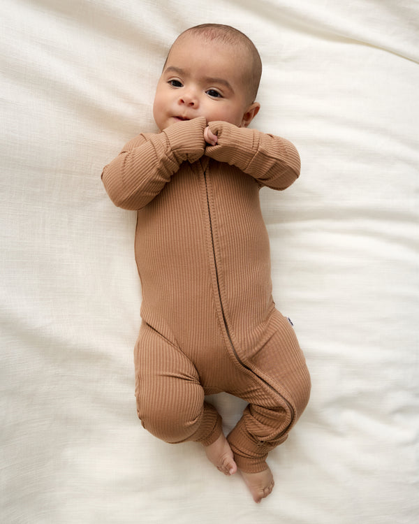 Aerial view of newborn wearing the Chestnut Brown Ribbed Zippy