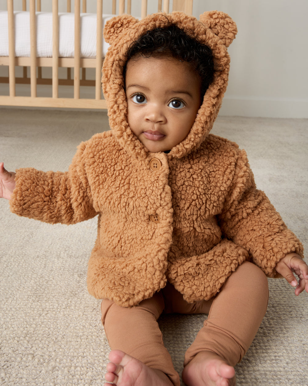 Sitting baby wearing the Chestnut Brown Sherpa Baby Jacket and leggings