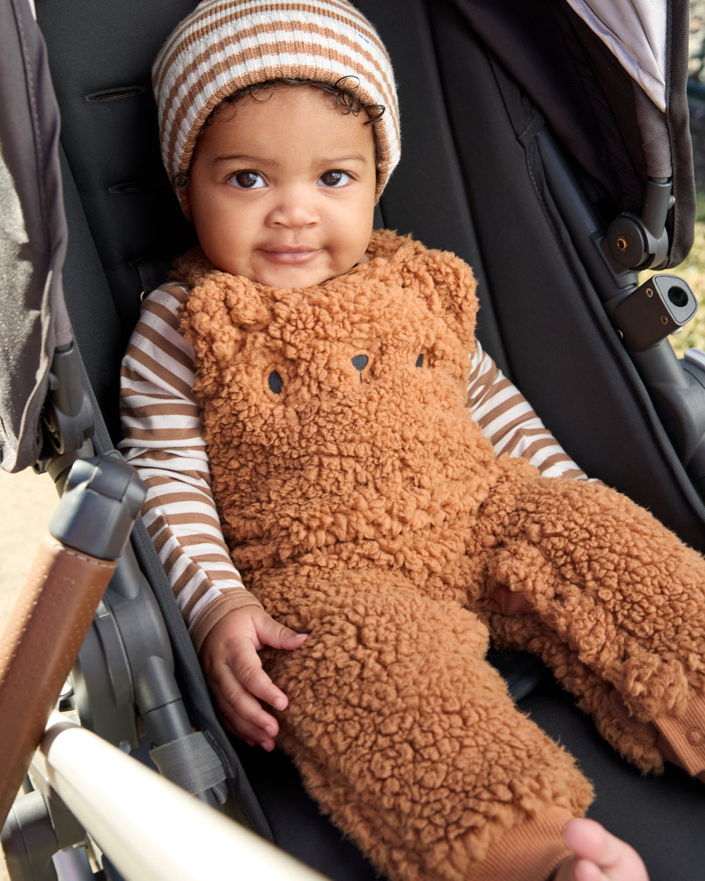 Baby in a stroller wearing the Chestnut brown Sherpa Baby Overall