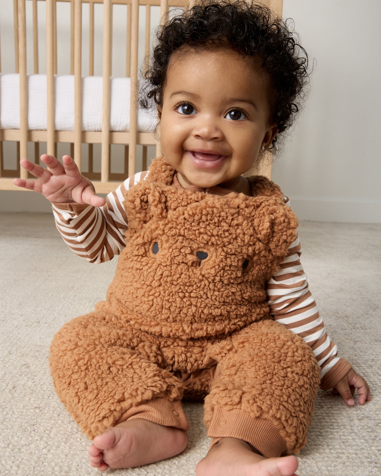 Sitting baby wearing the Chestnut brown Sherpa Baby Overall