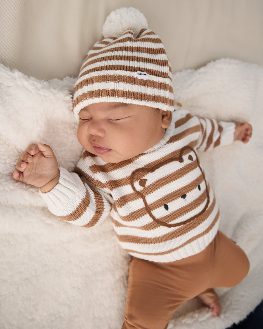 Newborn wearing the Chestnut Brown Stripe Bear Sweater and Beanie on a sherpa blanket