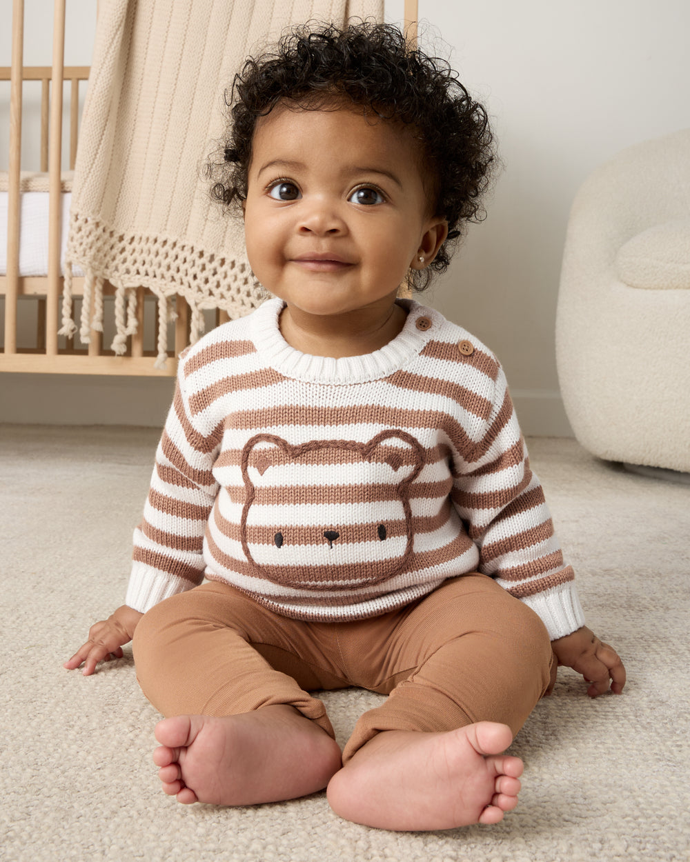 Sitting baby wearing the Chestnut Brown Stripe Bear Sweater and newborn leggings