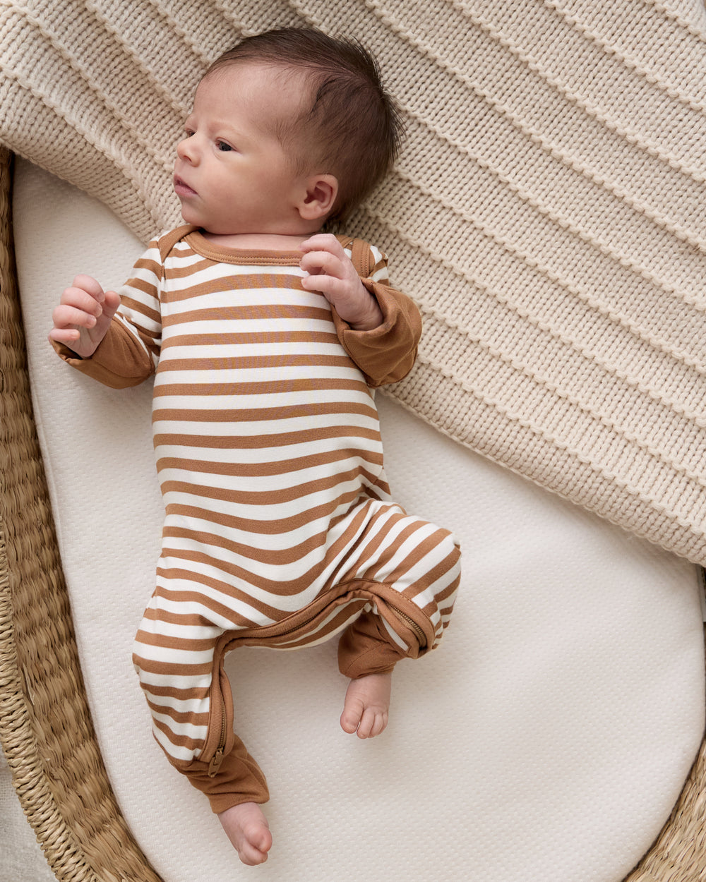 Aerial view of baby wearing the Chestnut Brown Stripe Crescent Zippy