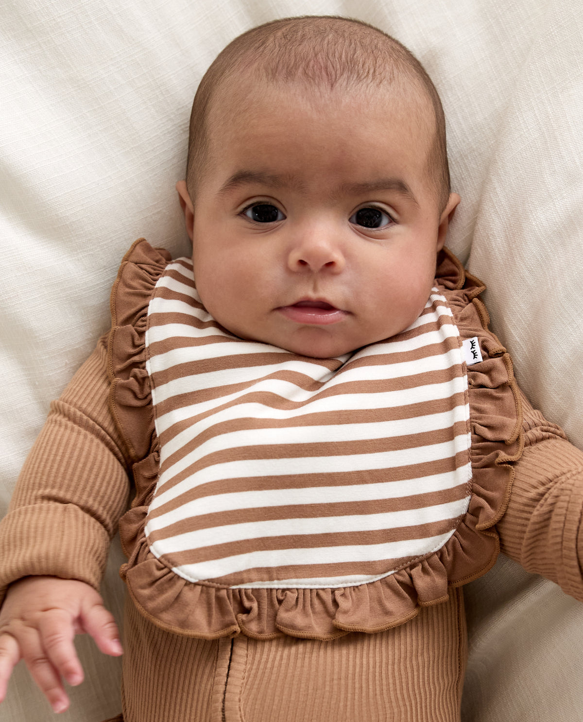 Baby wearing the Chestnut Brown Stripe Ruffle Bib