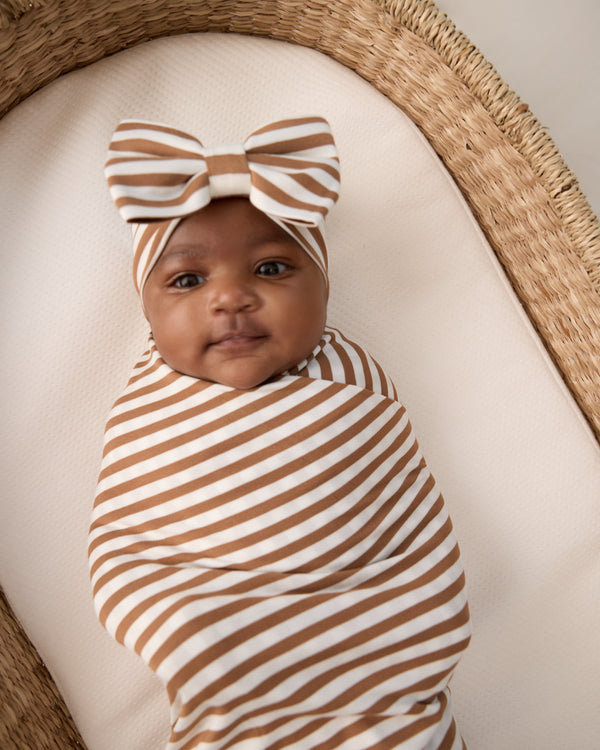 Close up of baby wearing the Chestnut Brown Stripe Swaddle & Luxe Bow Headband Set