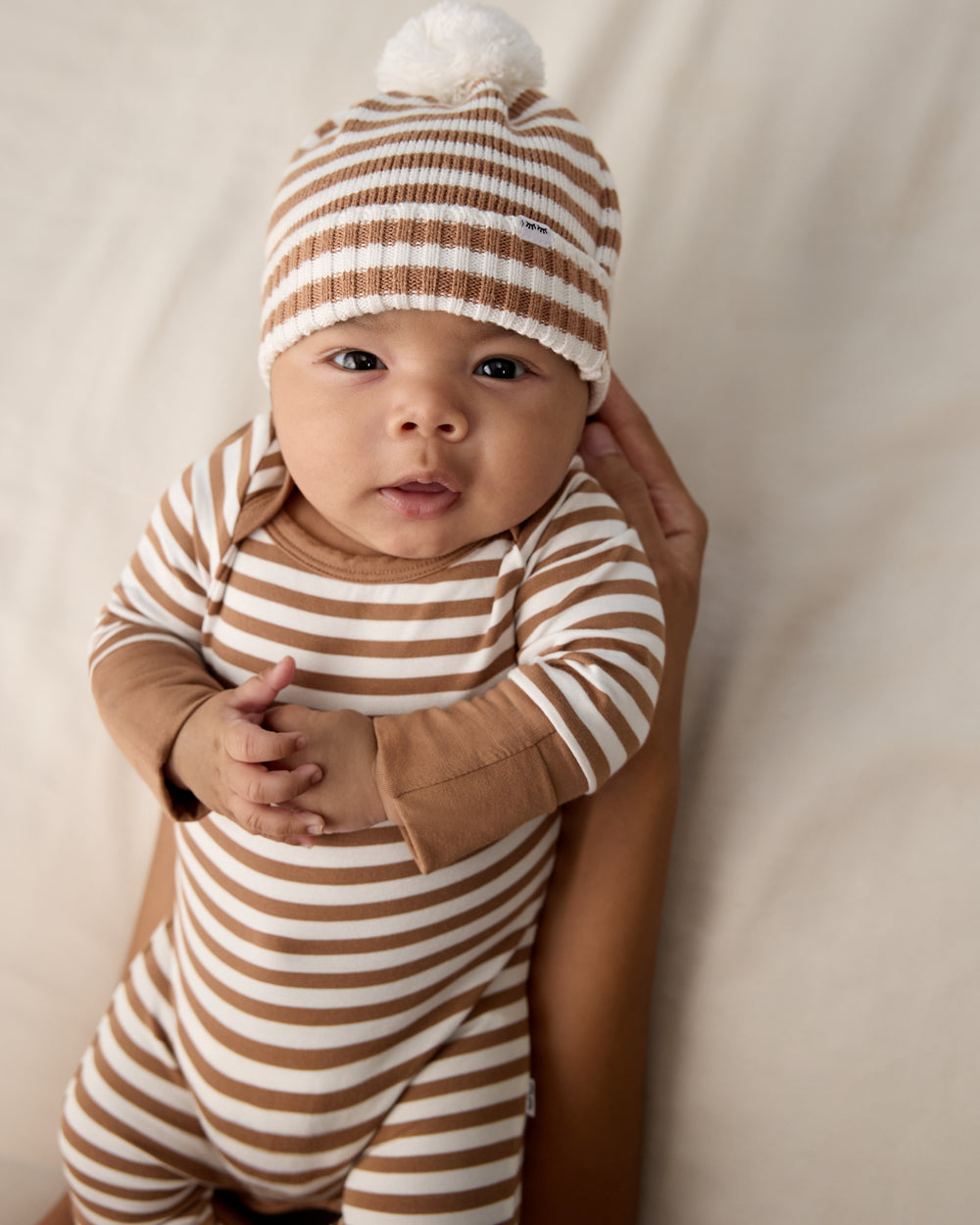 Adult holding baby wearing the Chestnut Brown Stripe Sweater Beanie Hat