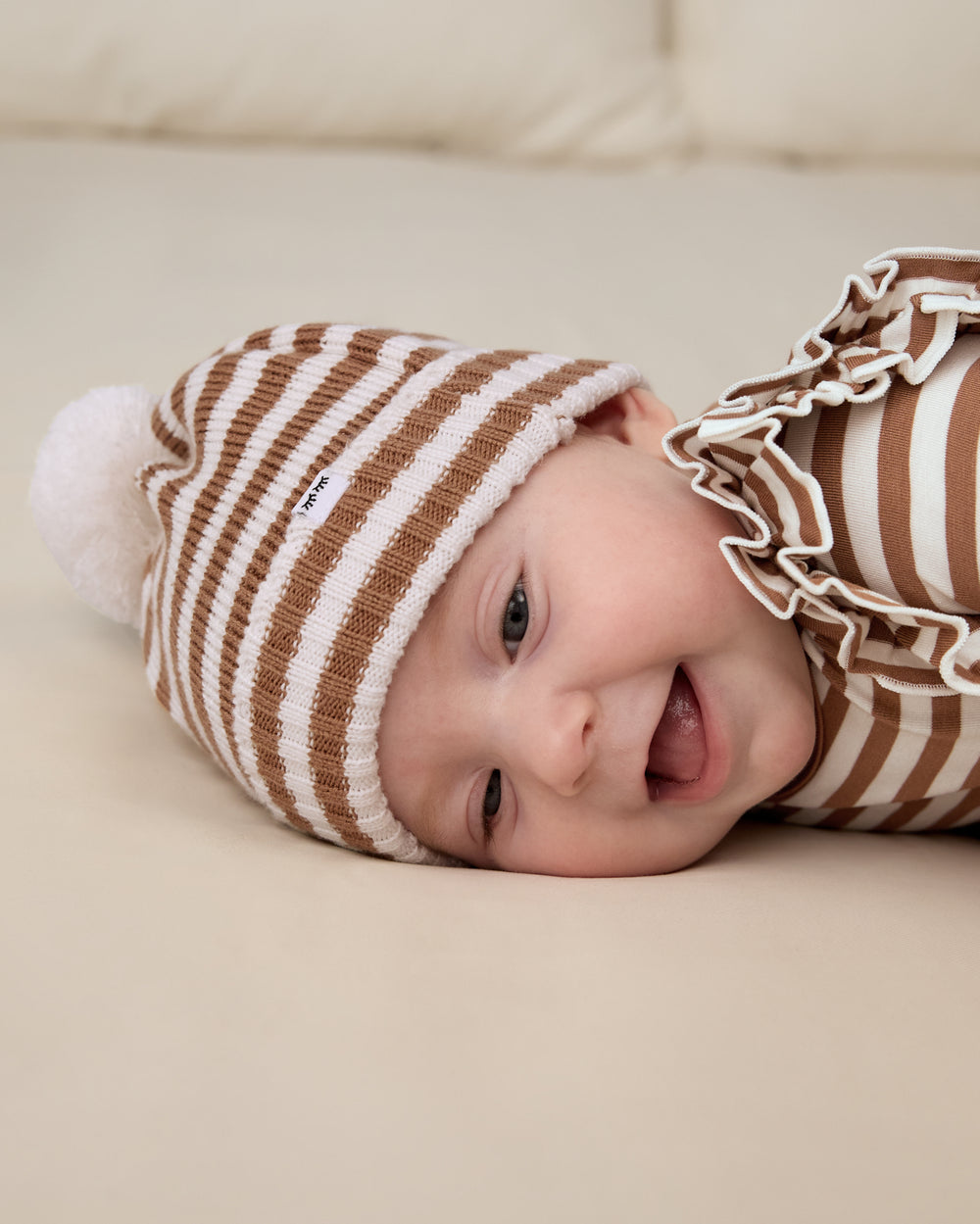 Close up of baby wearing the Chestnut Brown Stripe Sweater Beanie Hat