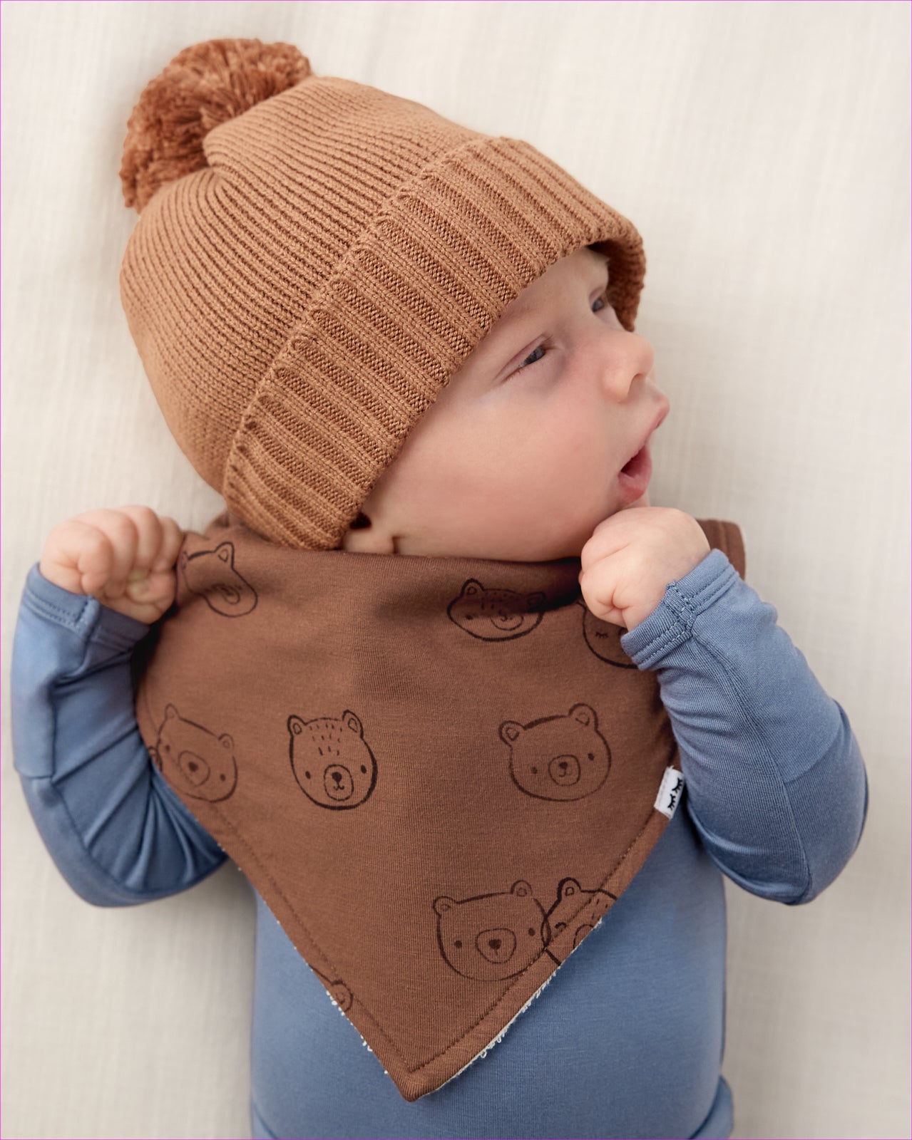 Close up of newborn boy wearing the Teddy Tracks Bandana Bib