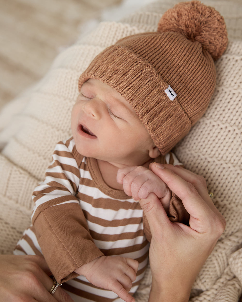 Baby wearing the Chestnut Brown Sweater Beanie Hat and Striped Zippy