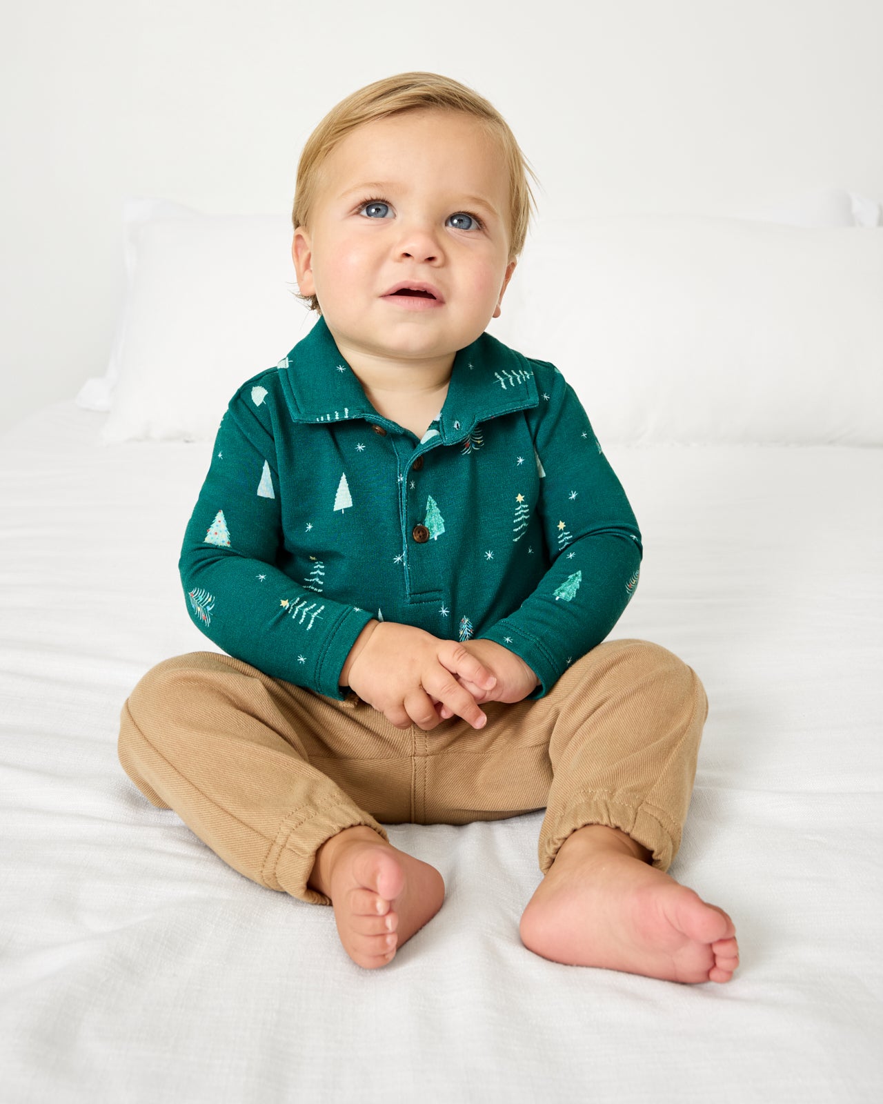 Baby wearing the Twinkling Trees Polo Bodysuit with khaki joggers