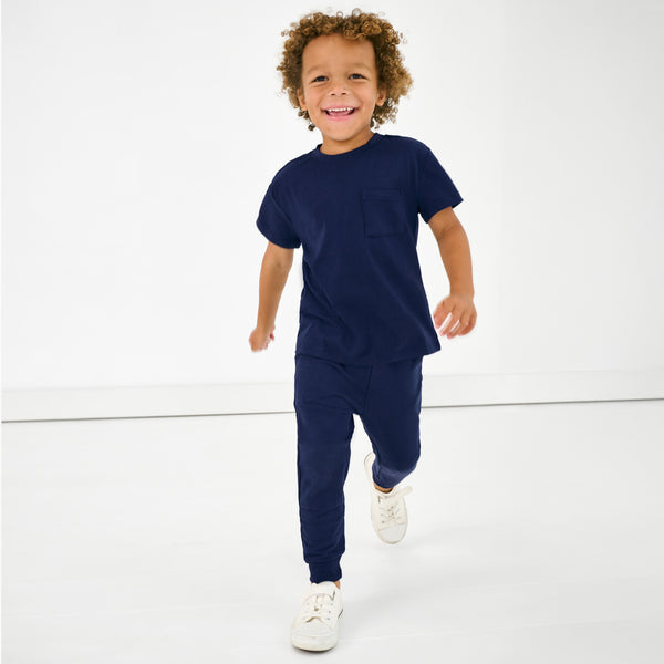 Child in motion wearing the Classic Navy Short Sleeve Relaxed Pocket Tee
