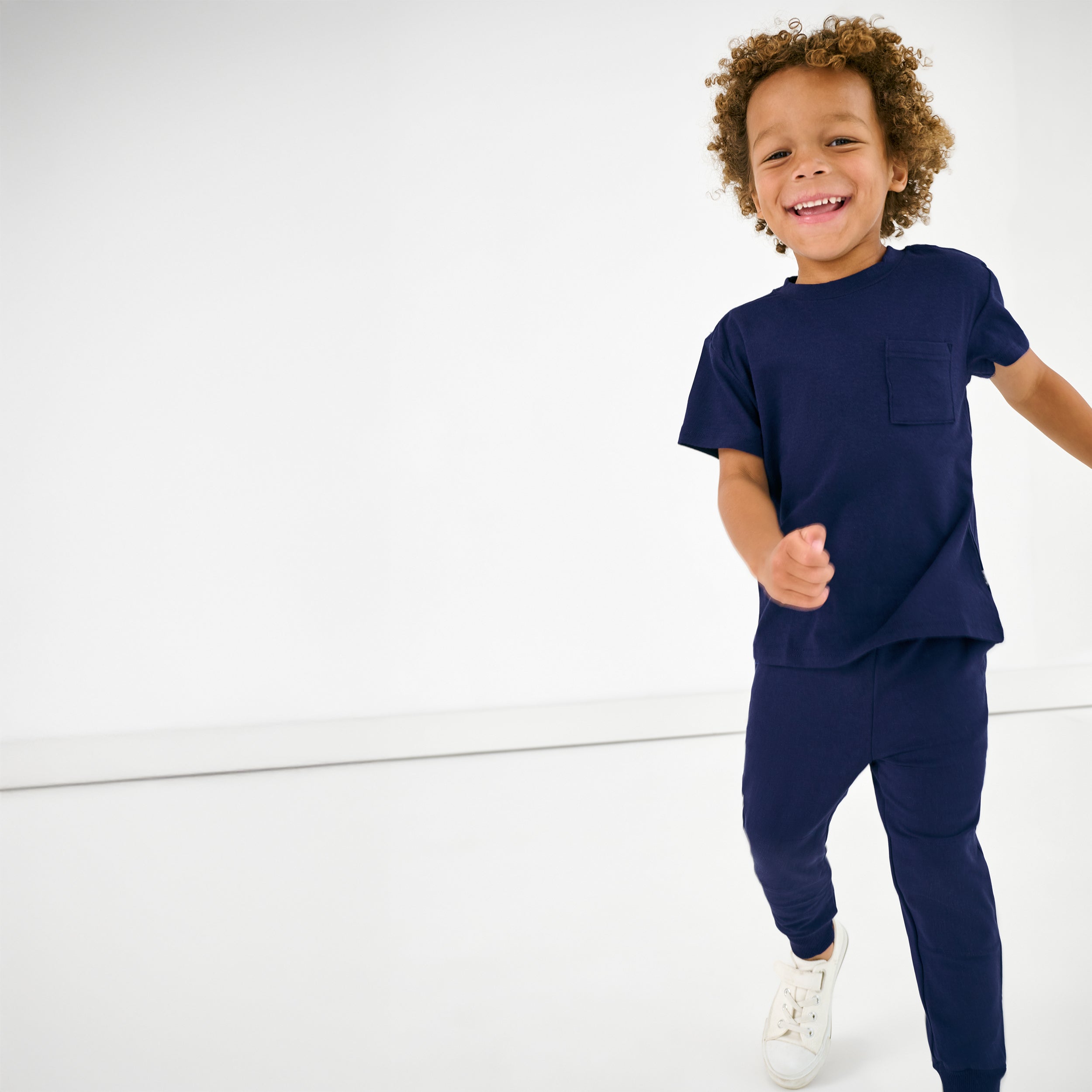 Alternate of child in motion wearing the Classic Navy Short Sleeve Relaxed Pocket Tee