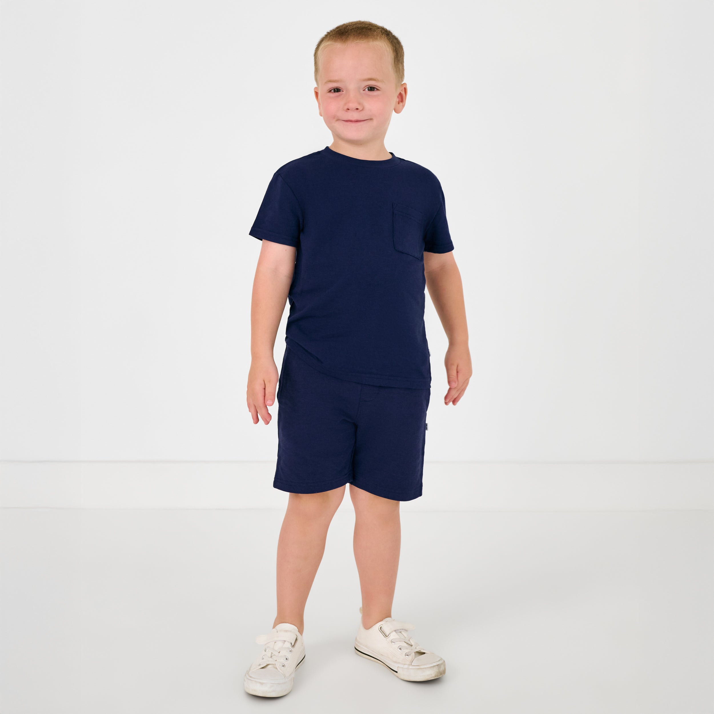 Standing child wearing the Classic Navy Shorts