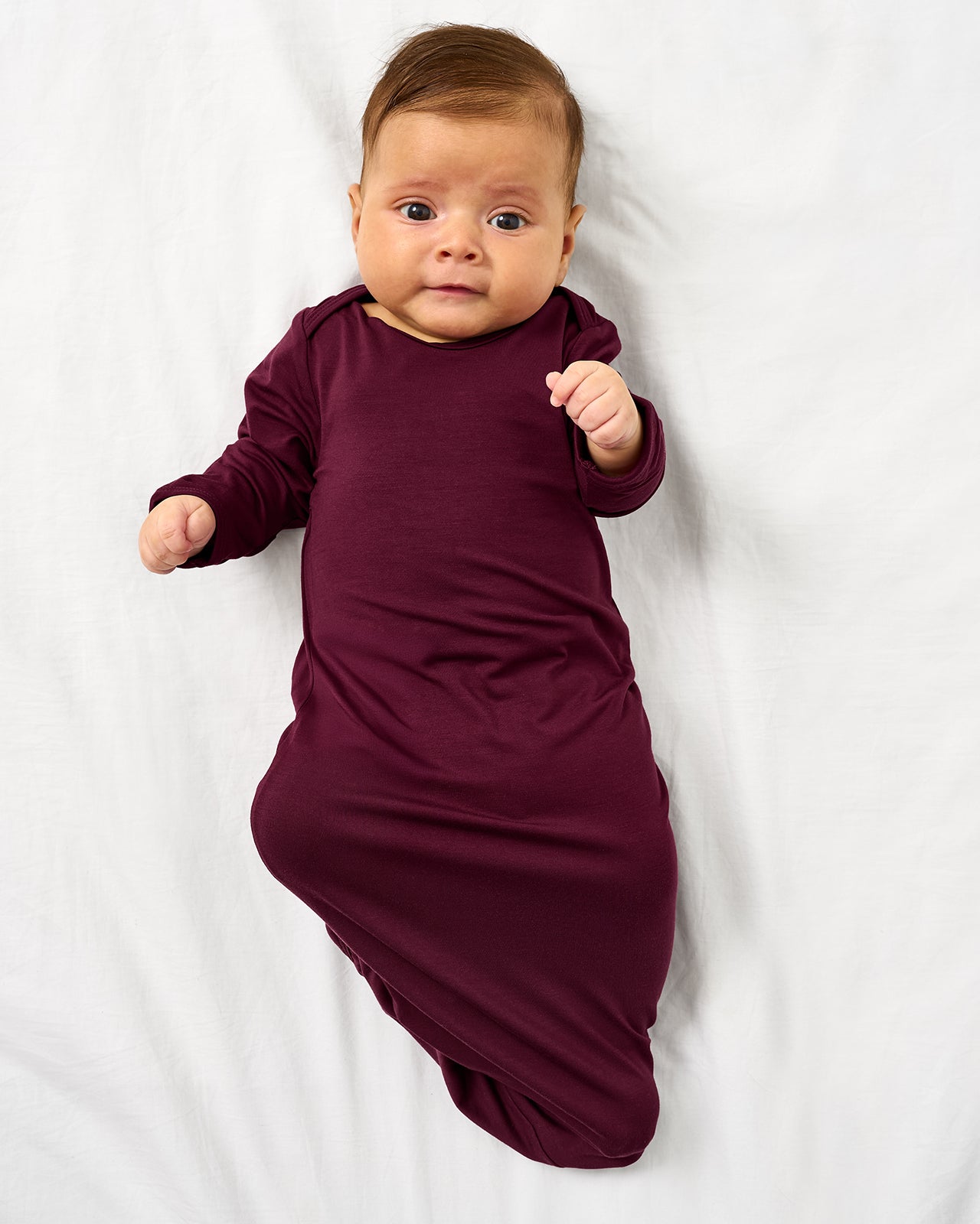 Aerial view of baby wearing the Classic Burgundy Infant Gown