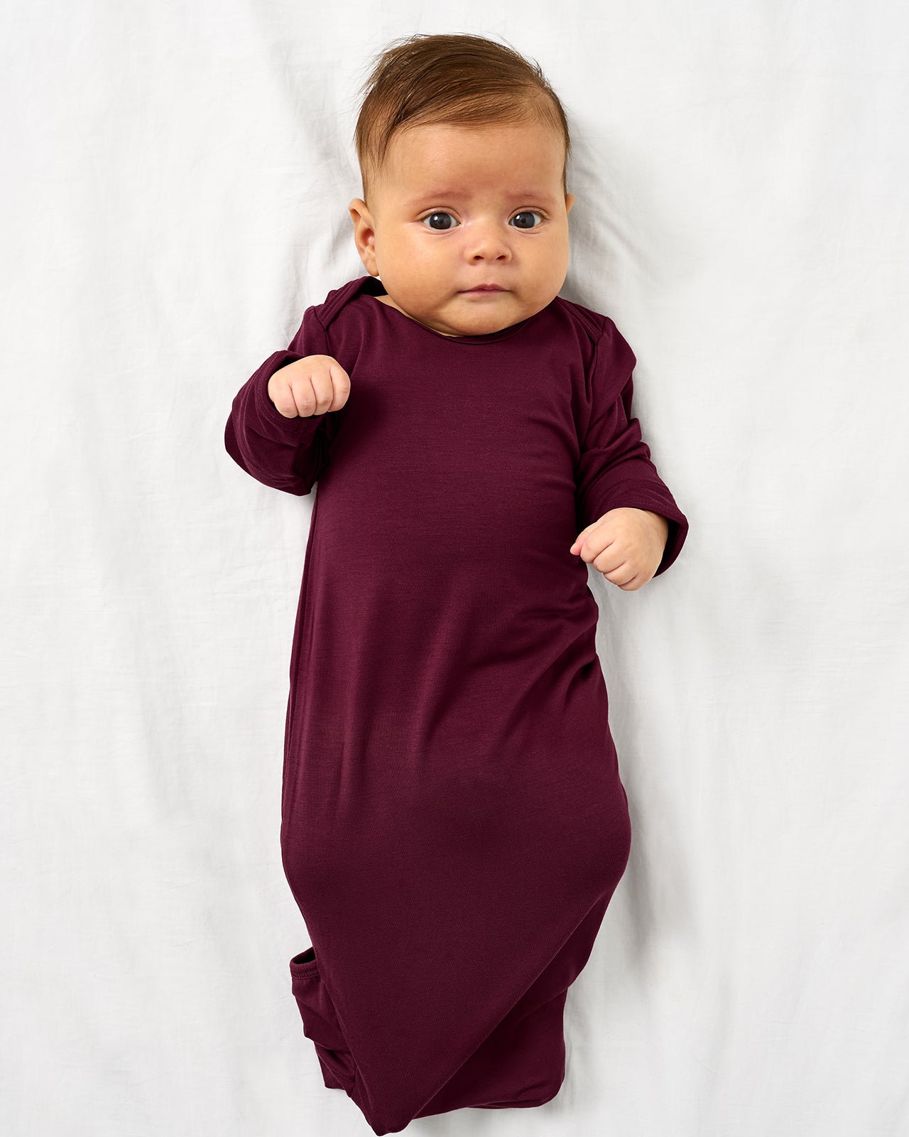 Alternate aerial view of baby wearing the Classic Burgundy Infant Gown