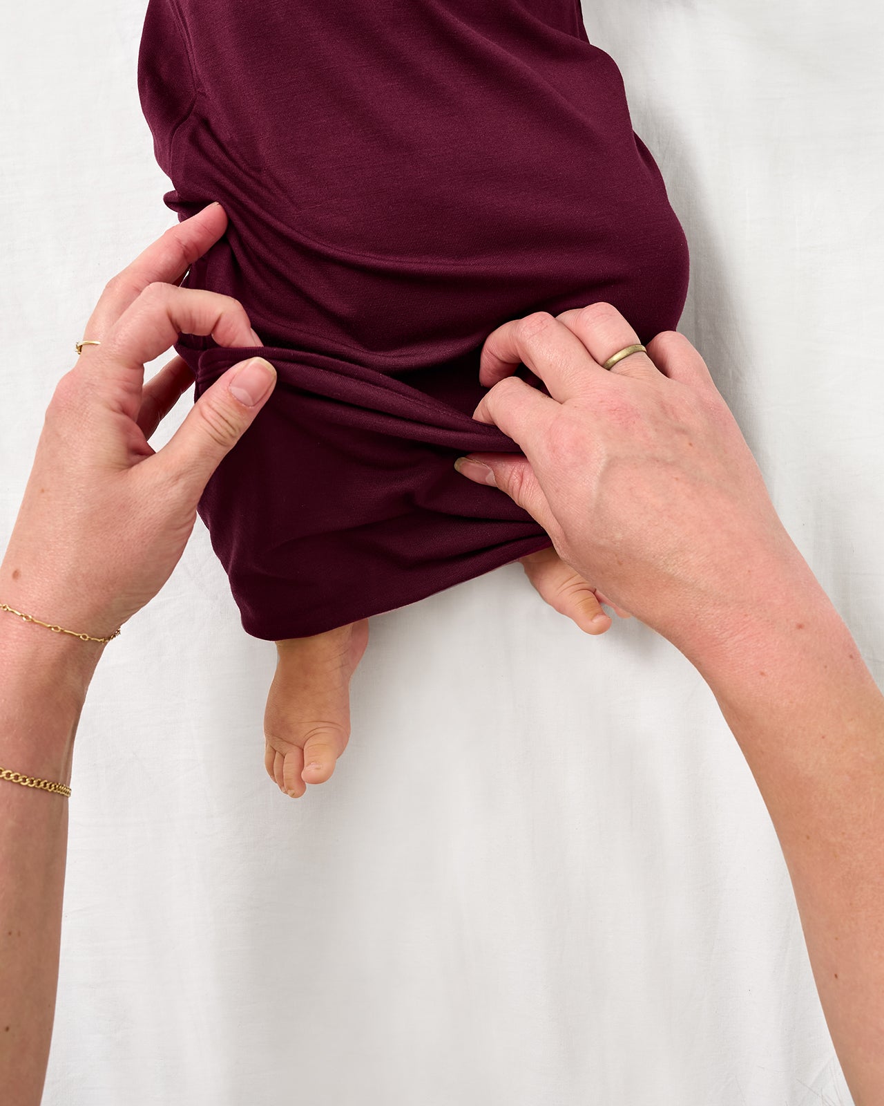 Adult demonstrating the envelope sweep on the Classic Burgundy Infant Gown