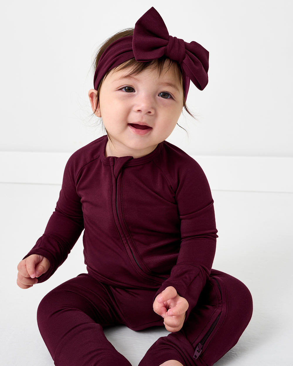 Baby wearing the Classic Burgundy Luxe Bow Headband
